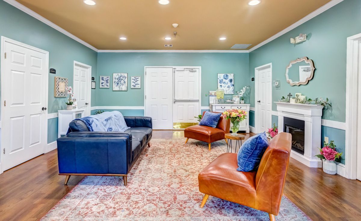 A living room filled with furniture and a fireplace.