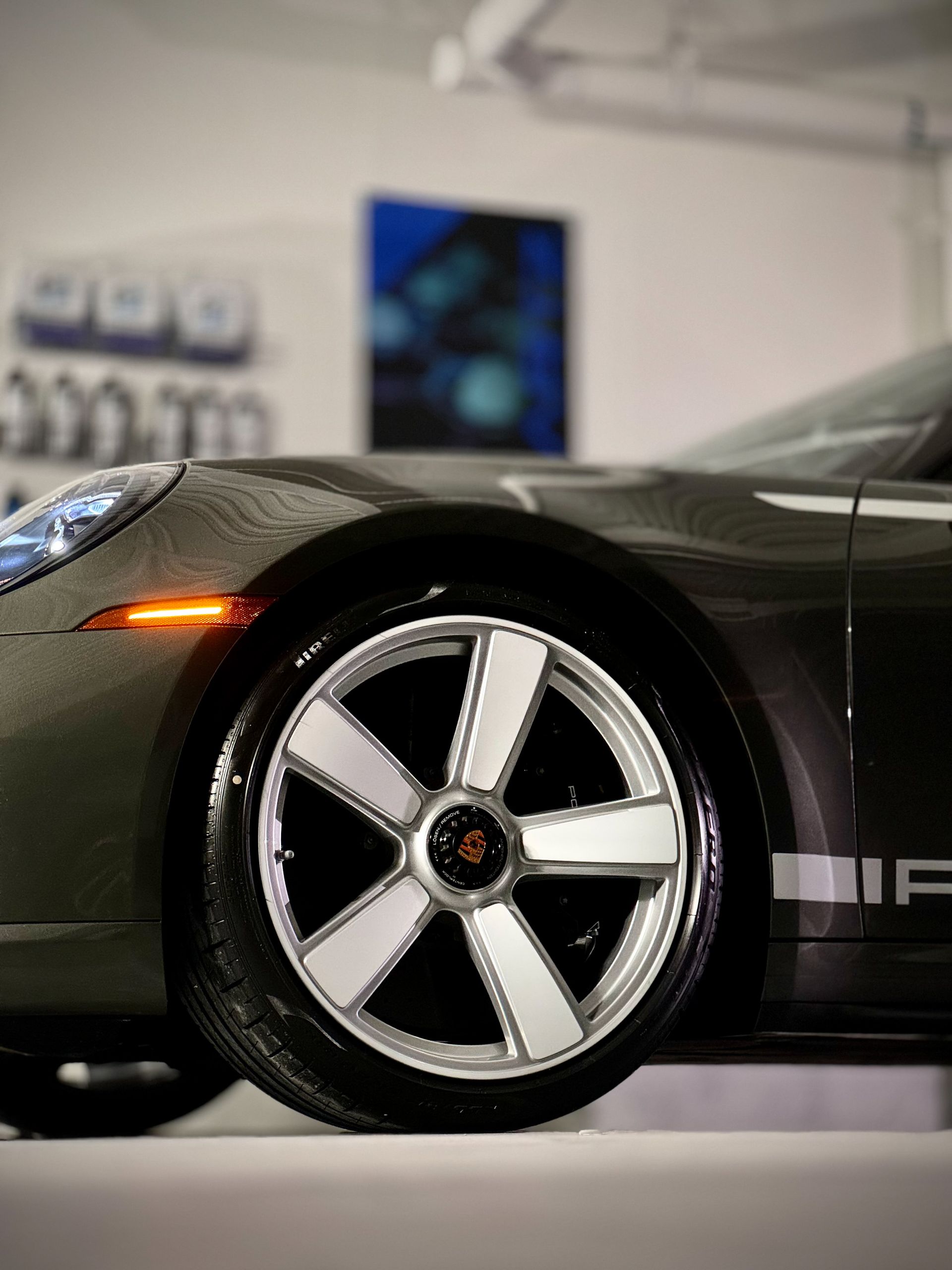 A porsche car is parked in a garage