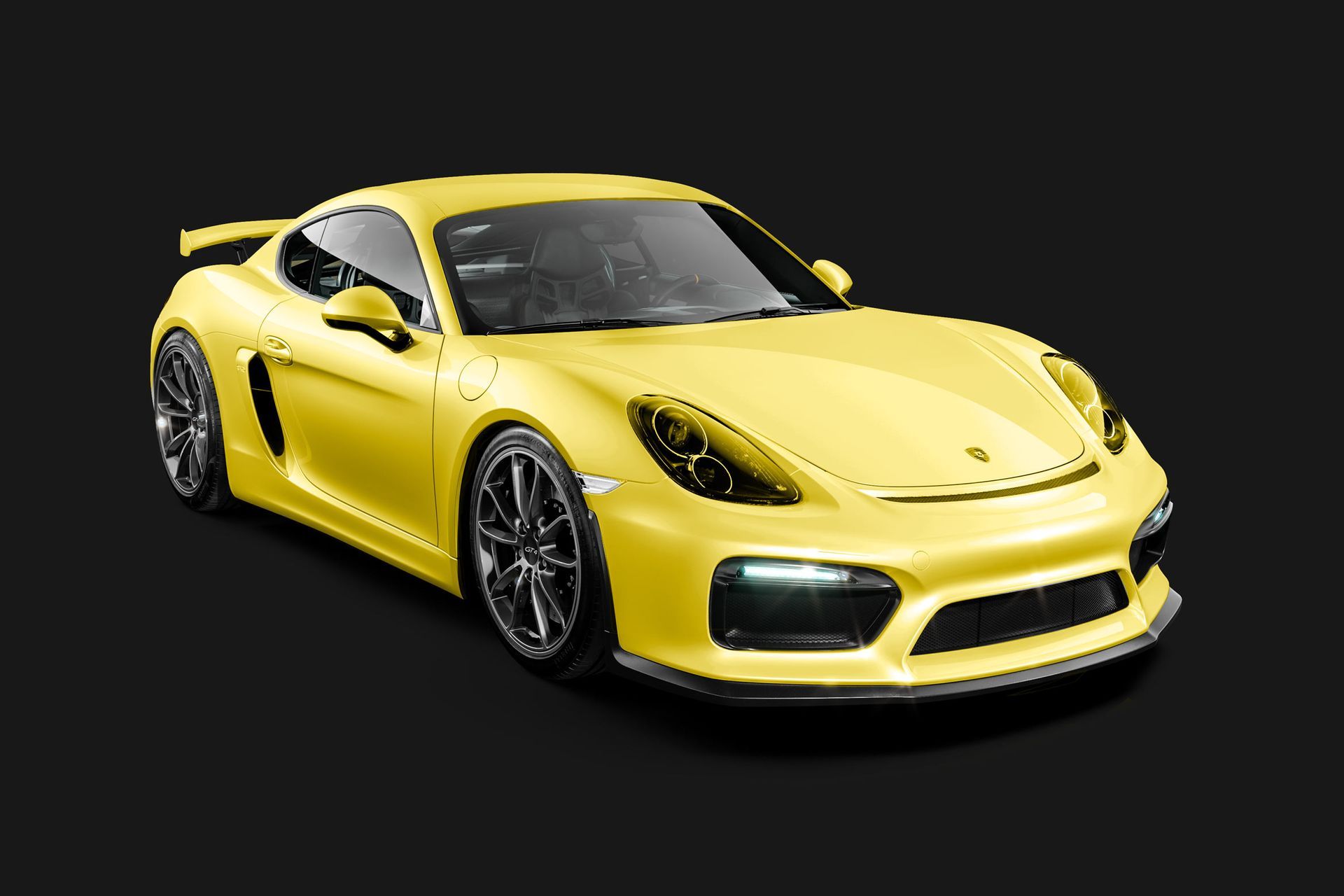 A yellow sports car is on a black background.