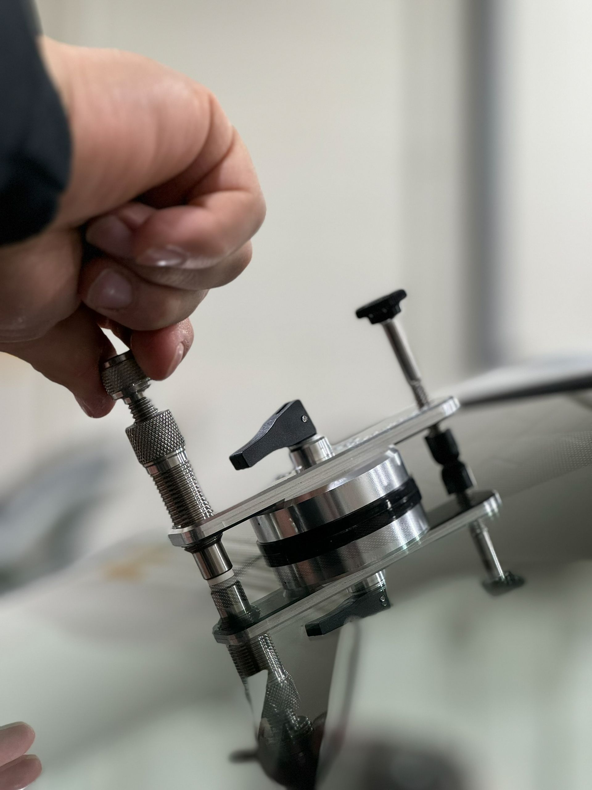 A person is fixing a broken windshield with a tool