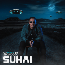 Homem de óculos escuros sentado em uma cadeira em uma estrada com OVNIs no céu noturno. O texto diz 