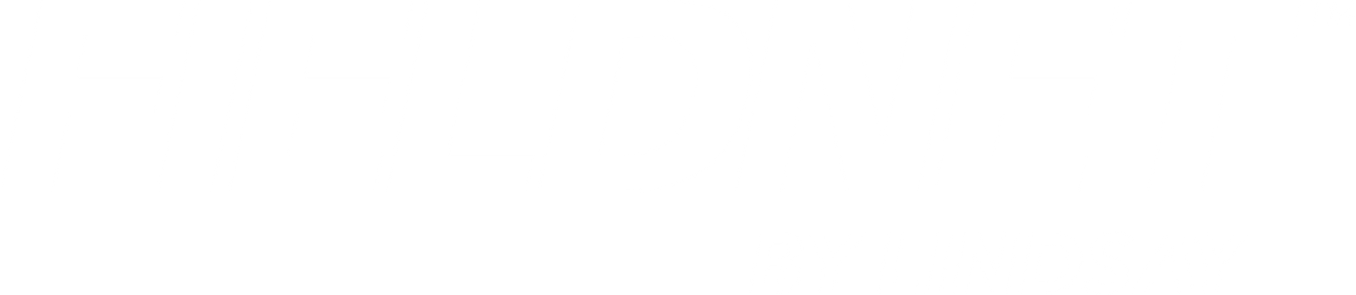 An empty, shallow wooden bowl sits on a dark, rustic table with a warm spotlight highlighting its textured interior.