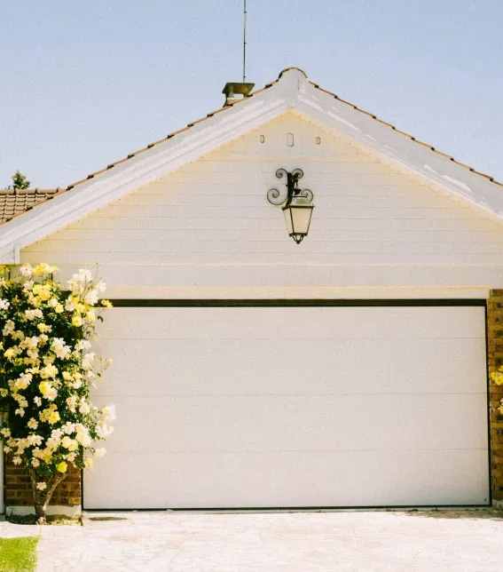 A white garage door with the letter j on it