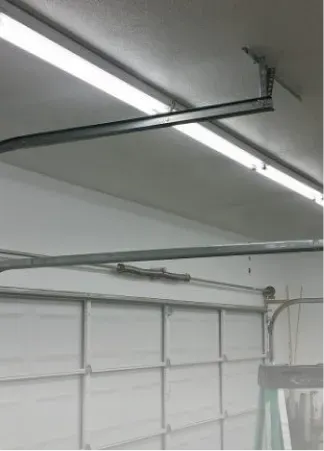 A garage with a ladder hanging from the ceiling