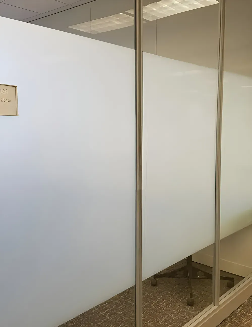 Frosted glass office partition with metal frame. Interior view.