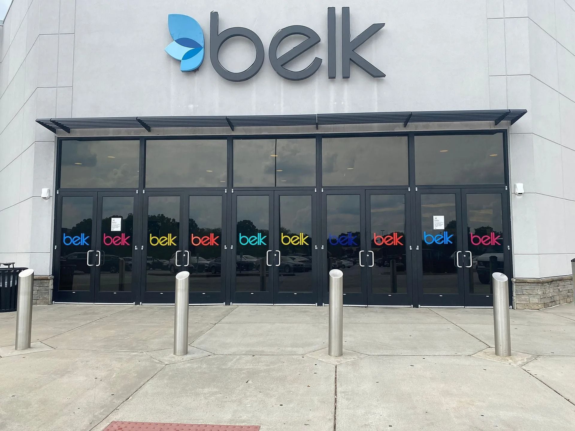 Belk store entrance with black doors and colorful 