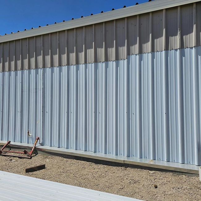 a large metal building with a lot of lines on it