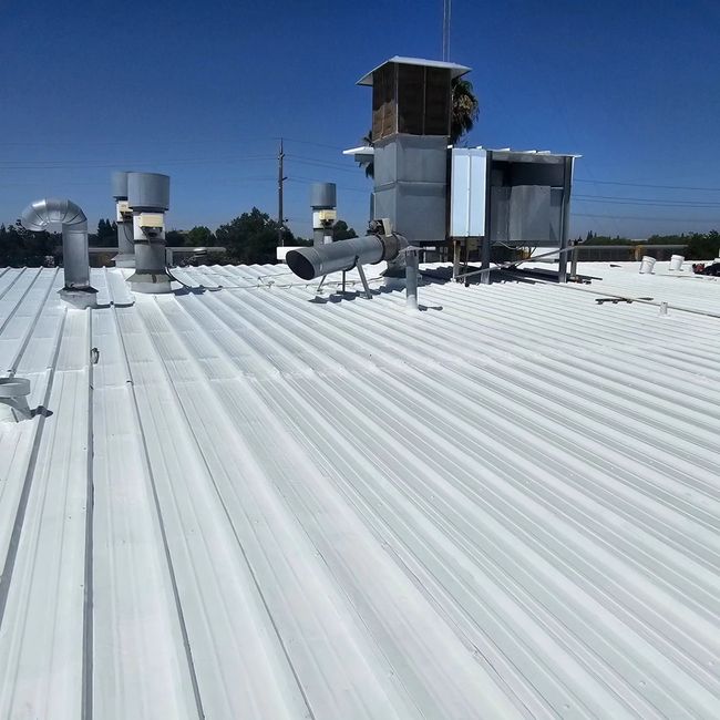 a white roof with a blue sky in the background