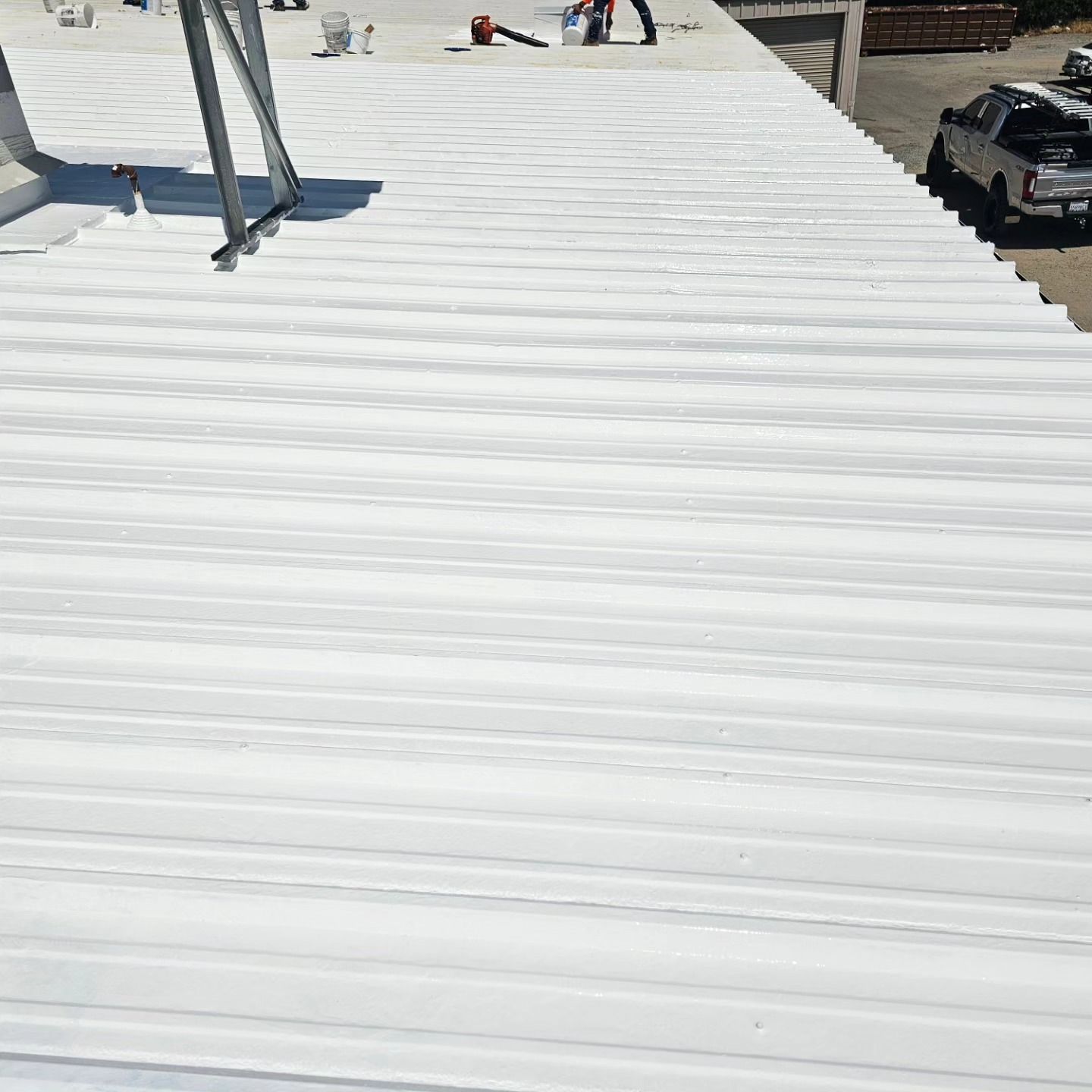 a white roof is being painted on a building