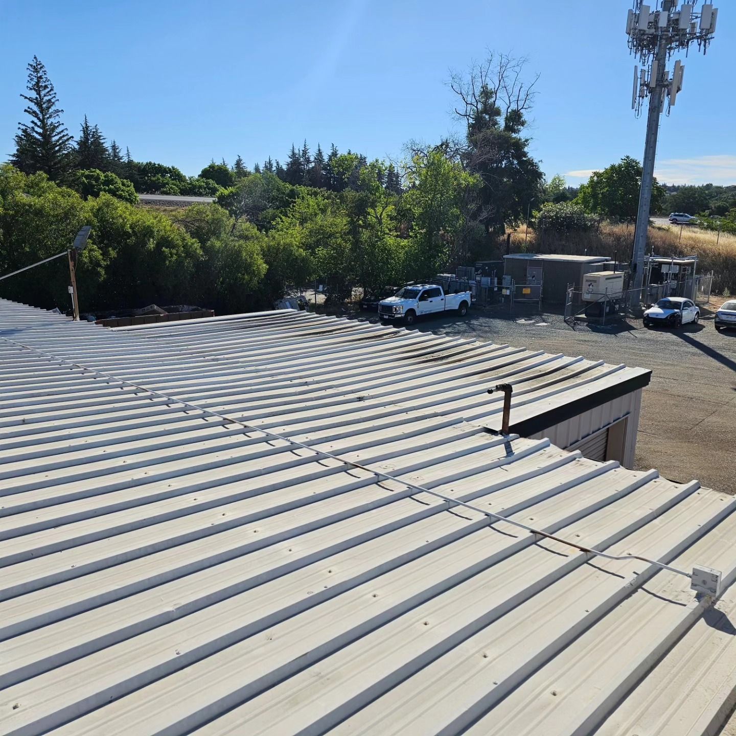 rooftop view of a white truck parked in a parking lot