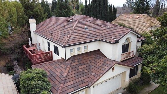 an aerial view of a large house with a tiled roof