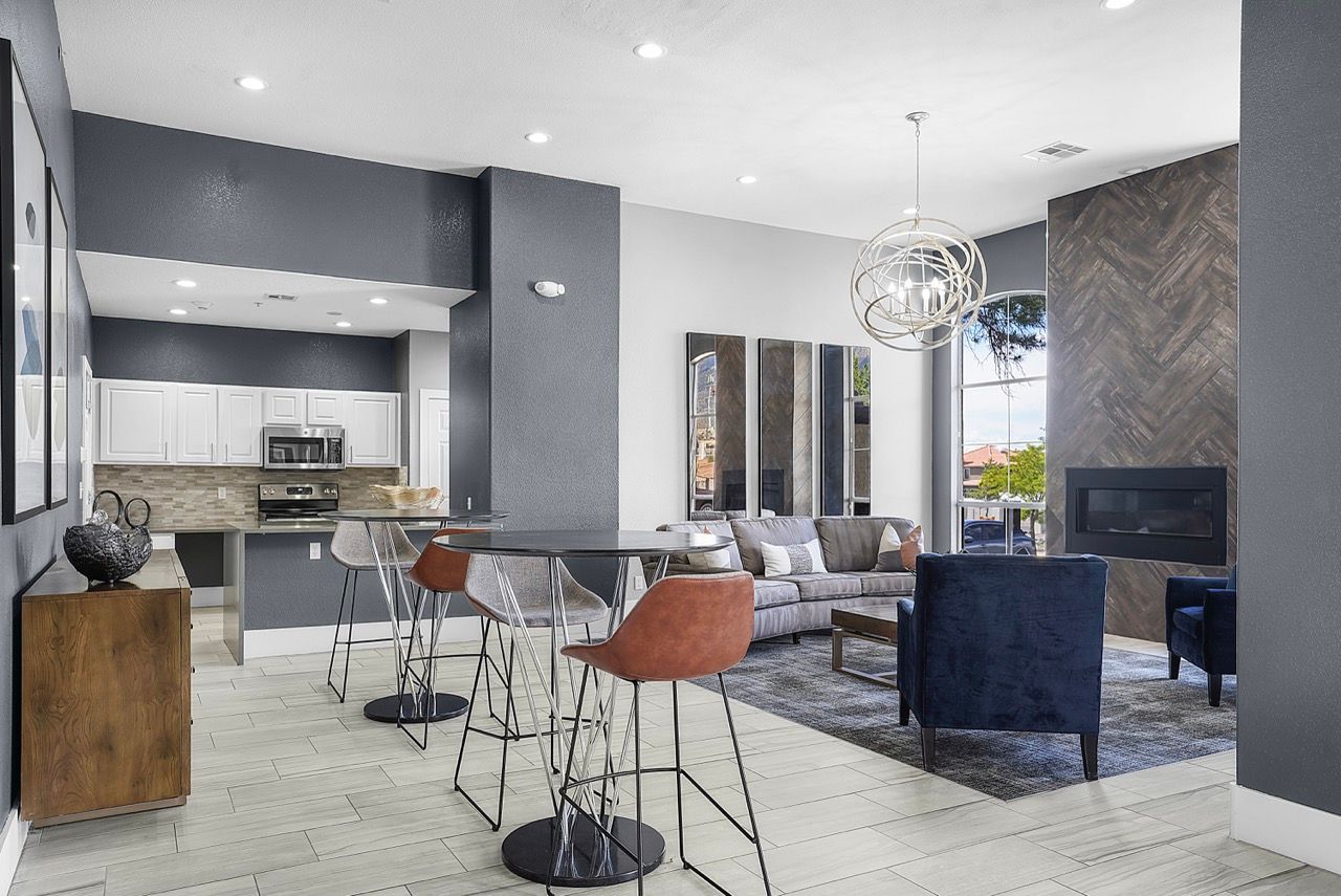Open-concept apartment living area with kitchen island, bar seating, and a fireplace.