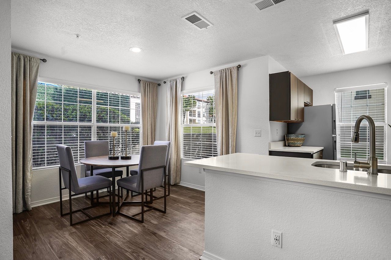 Open-concept kitchen and dining area with a wall of windows and an island.