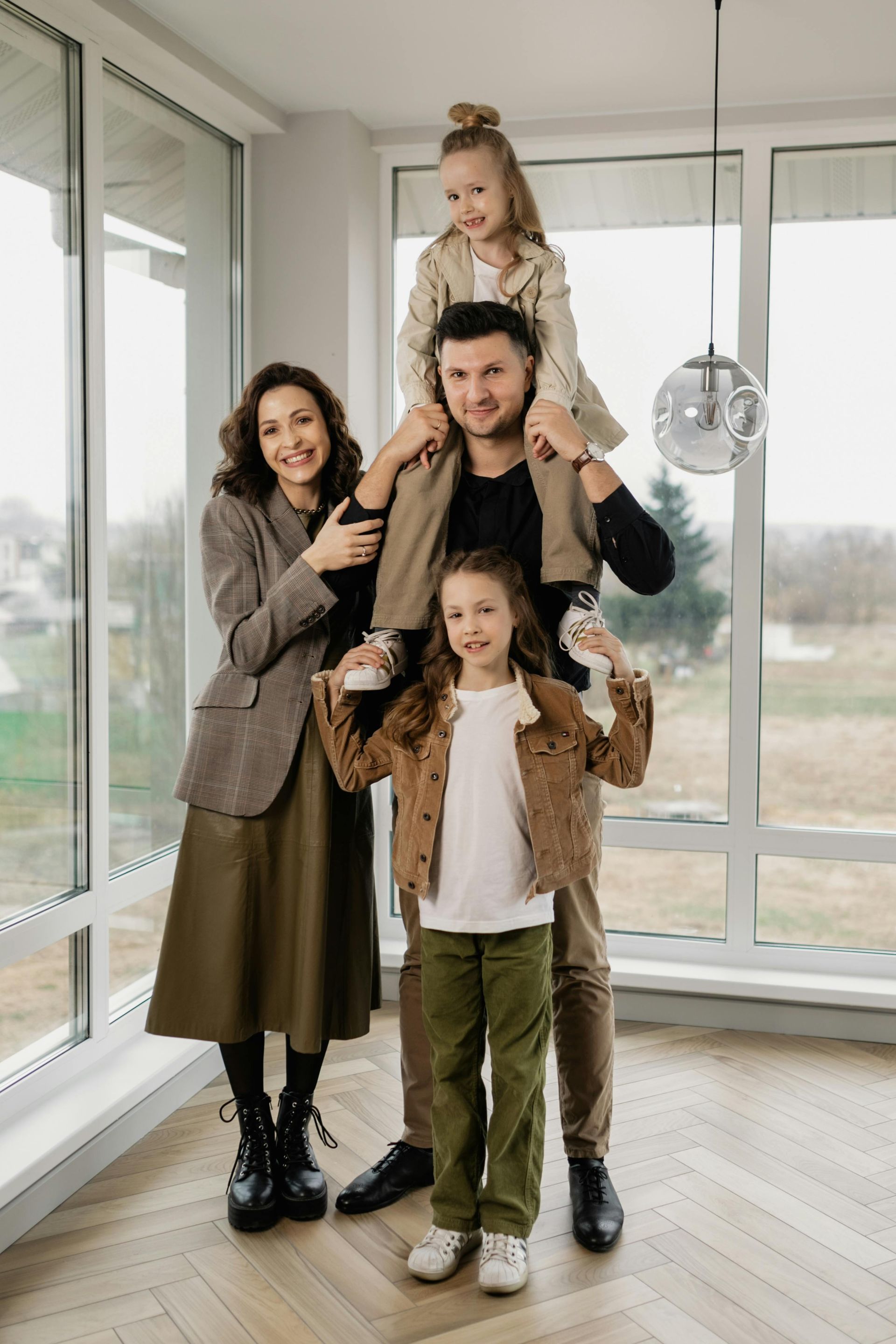 A family is posing for a picture in their new home.