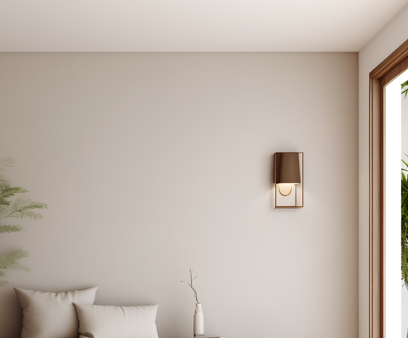 A living room with a couch and a lamp on the wall.