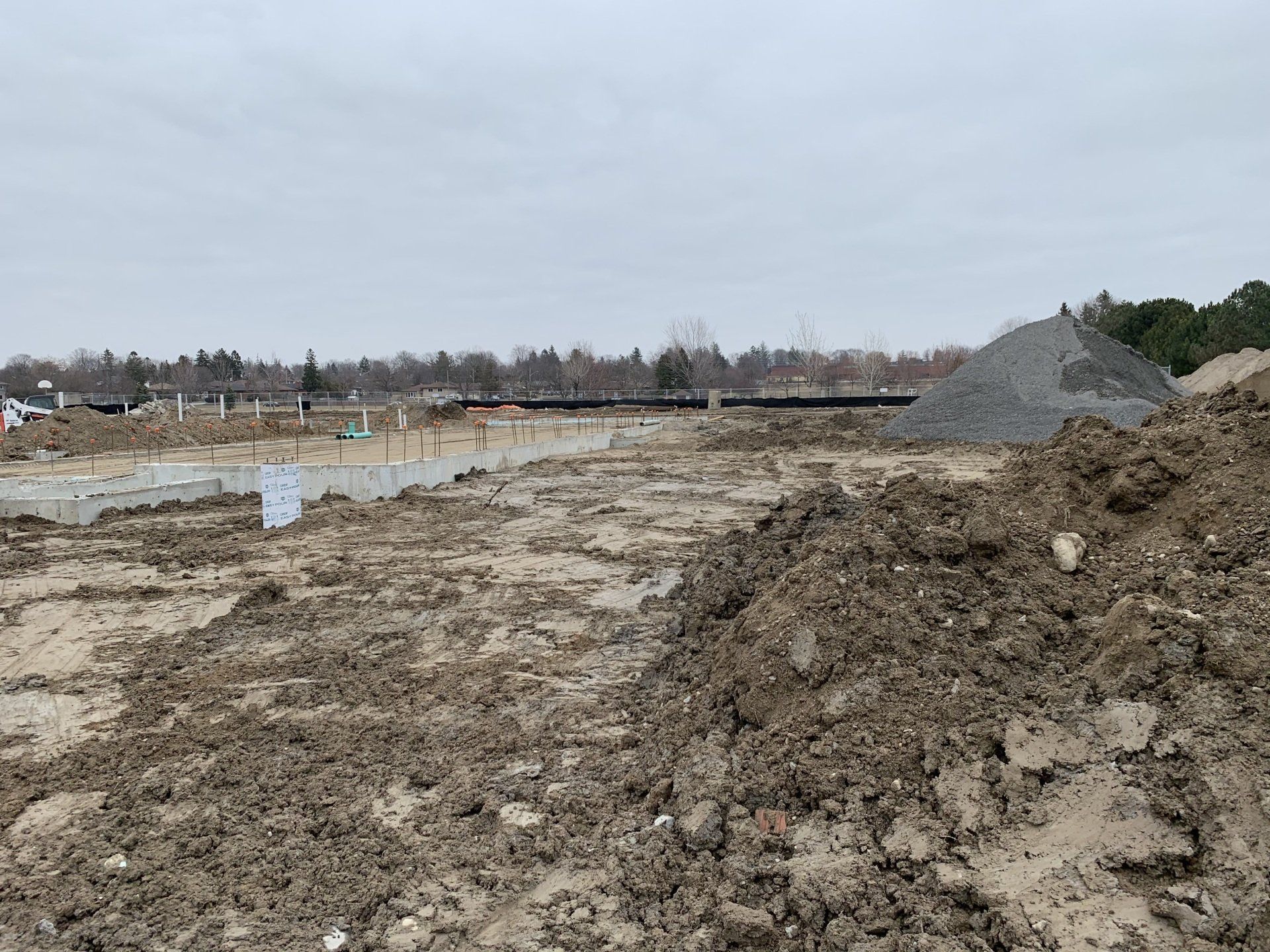 A pile of dirt is sitting in the middle of a dirt field.