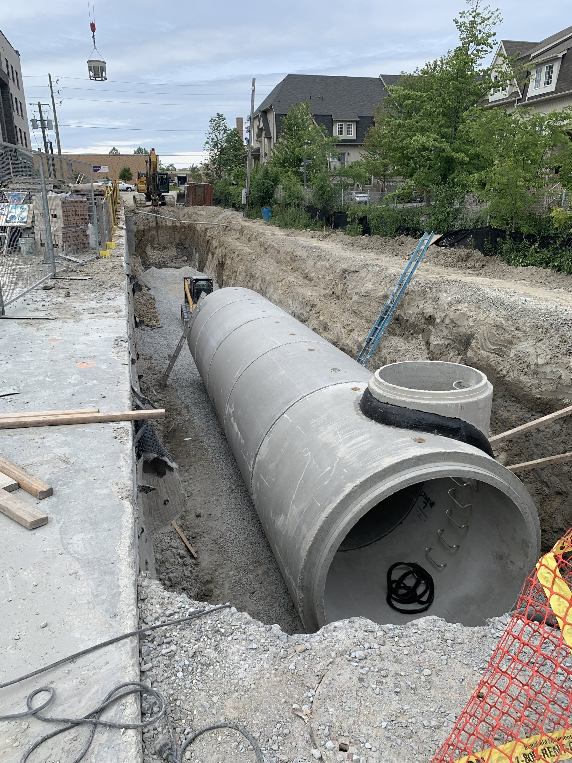 A large concrete pipe is sitting in the middle of a construction site.