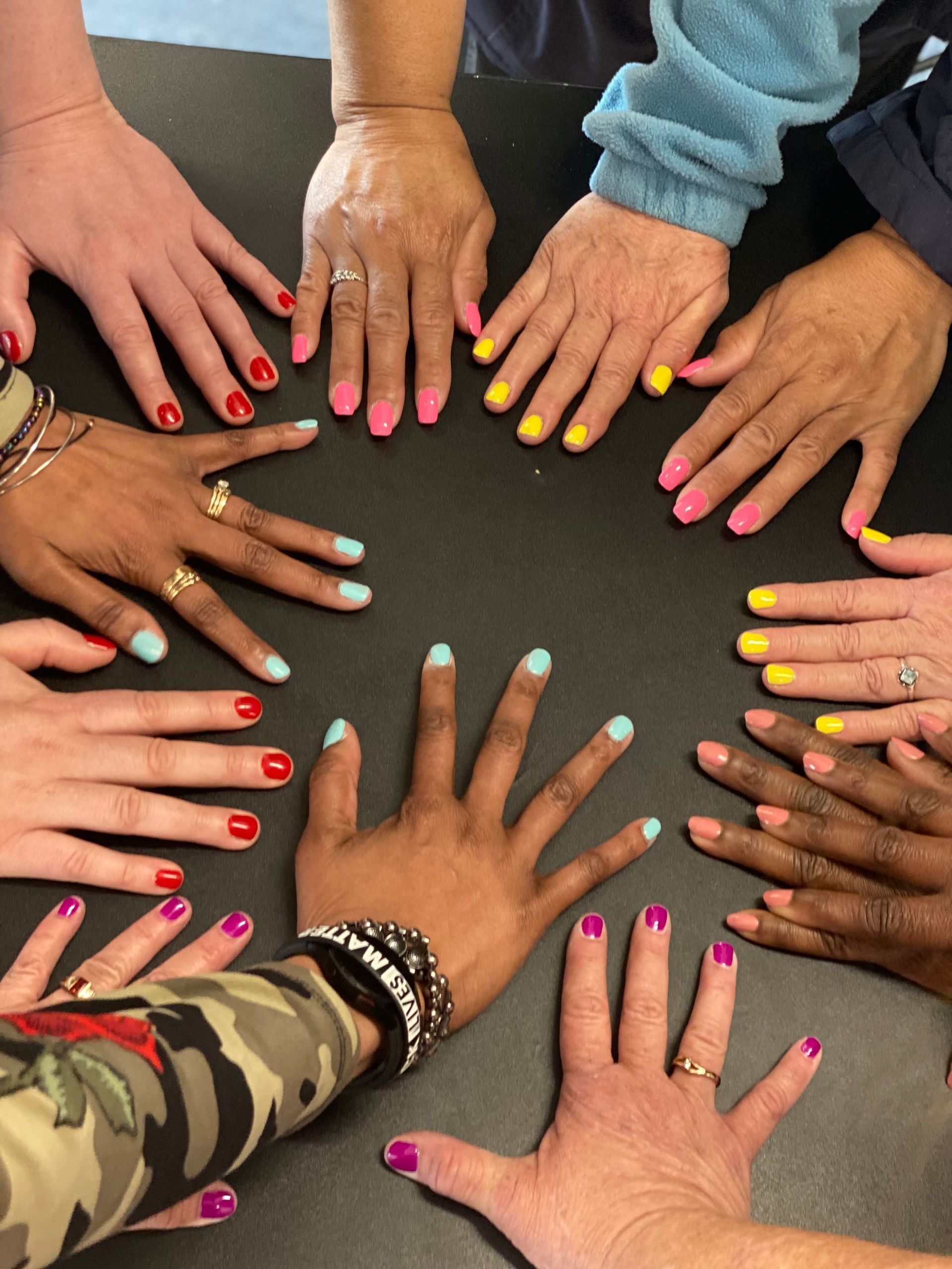 attendees of workshop showcasing painted nails