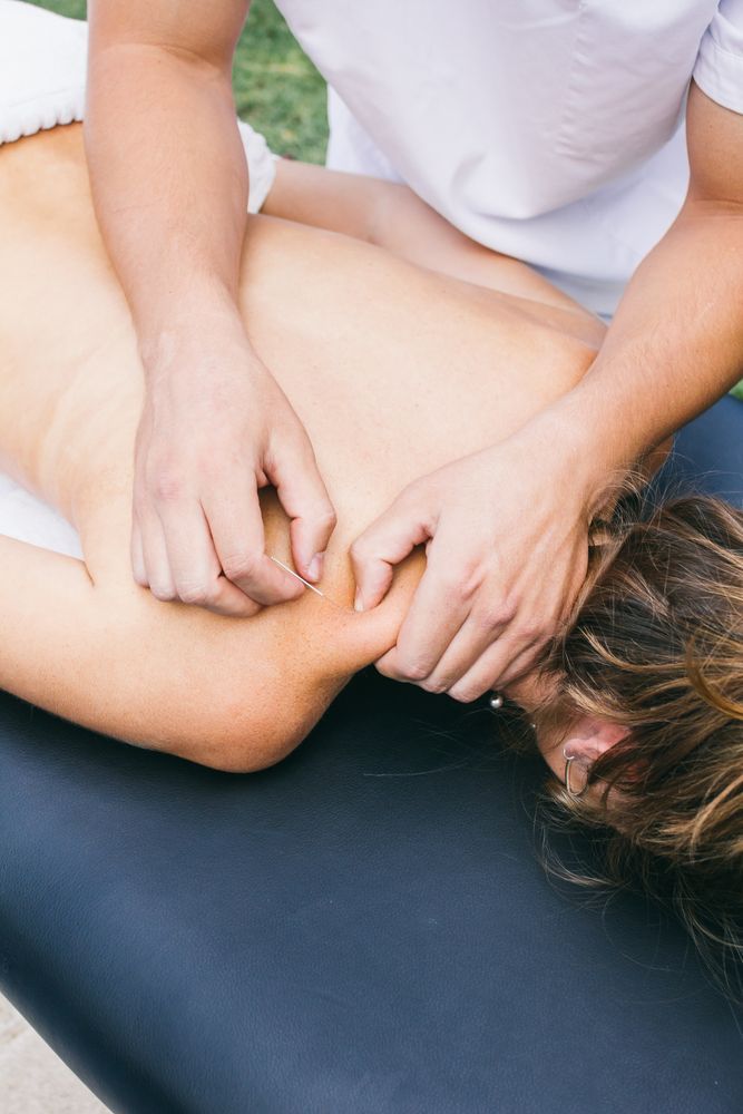 Massage Therapist Working On A Person's Back And Shoulder, Outdoors — Integrate Health In Marian, QLD