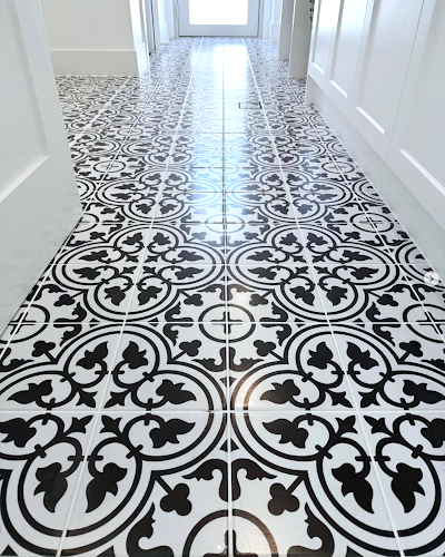 Black and White Patterned Tile Floor in a Hallway, Leading Toward a Doorway — Seeto Tiling in Nelson Bay, NSW