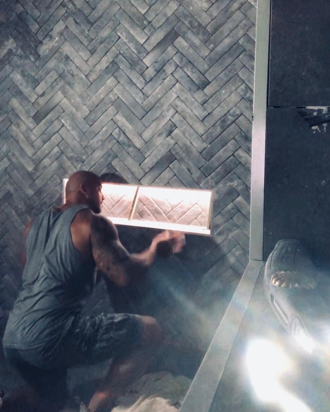 A man is installing an LED light around a tiled shower — Seeto Tiling in Fingal Bay, NSW