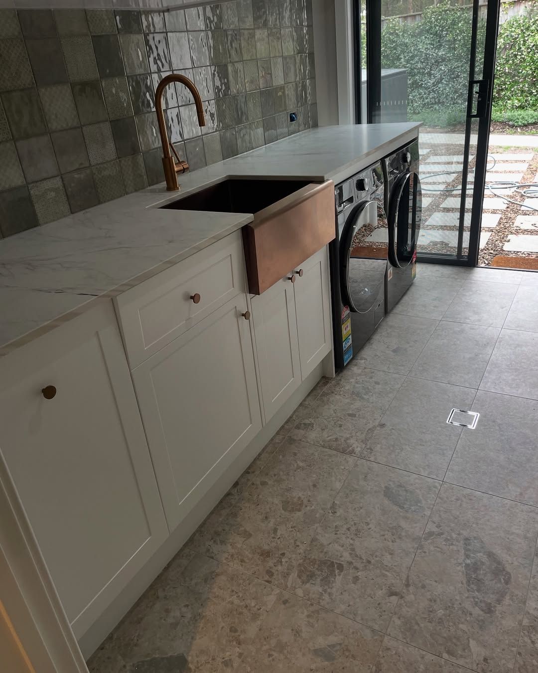 Laundry Room With Cabinets, Marbled Countertop, Sink and Faucet, Tiled Backsplash — Seeto Tiling in Medowie, NSW