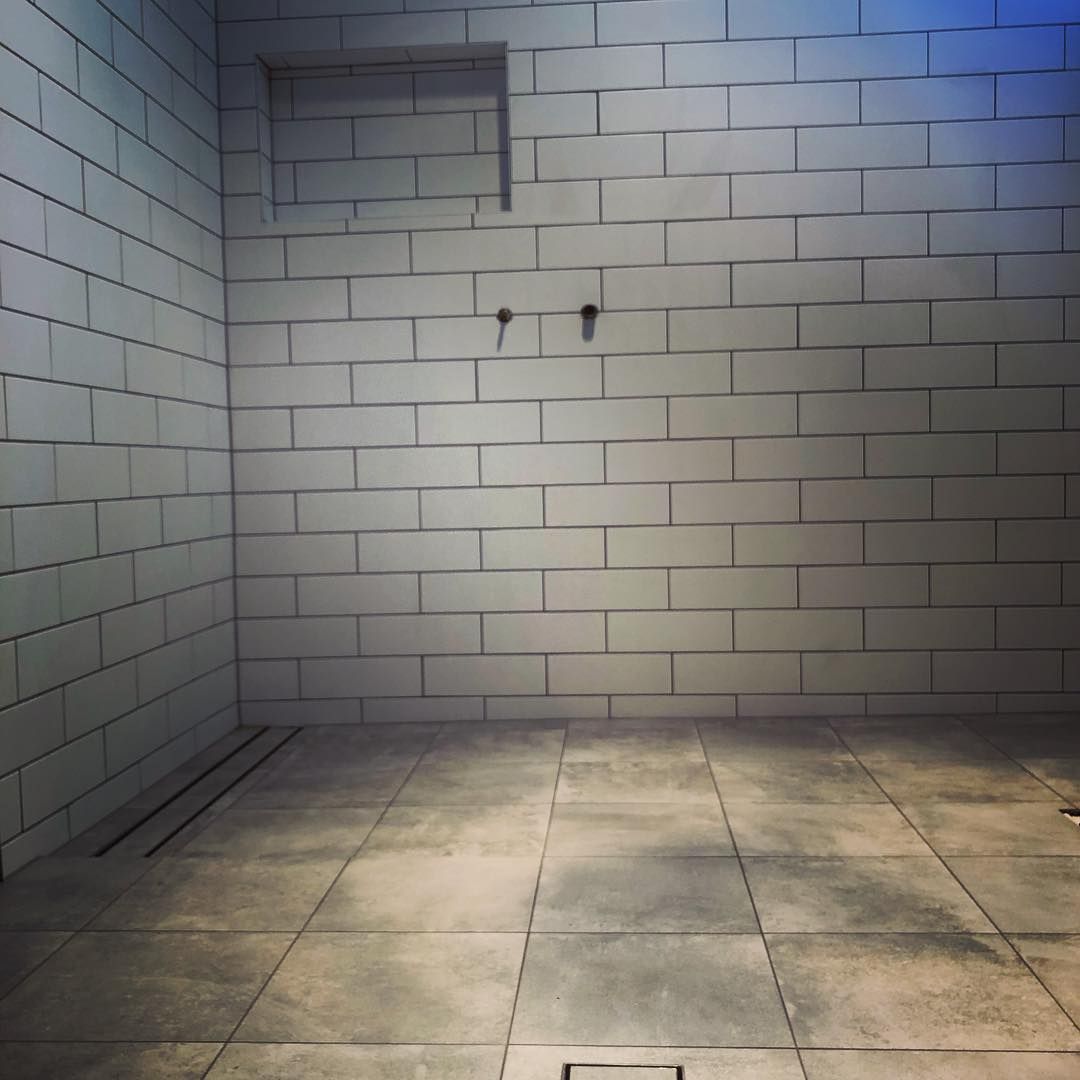 A Modern Shower Stall With White Brick Walls and Gray Tile Floor — Seeto Tiling in Fingal Bay, NSW