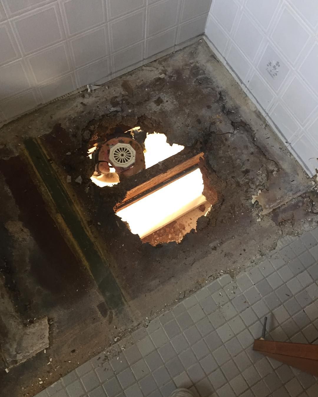 Hole in Bathroom Floor Exposing Drain and Subfloor — Seeto Tiling in Medowie, NSW