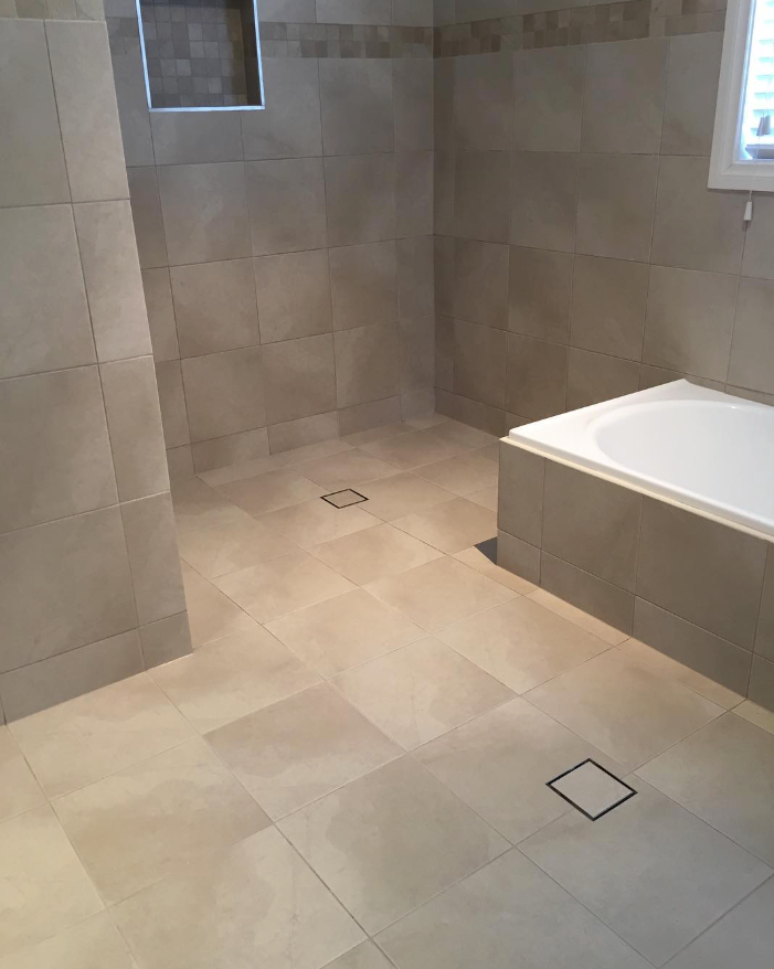 A neutral coloured bathroom fully tiled — Seeto Tiling in Fingal Bay, NSW