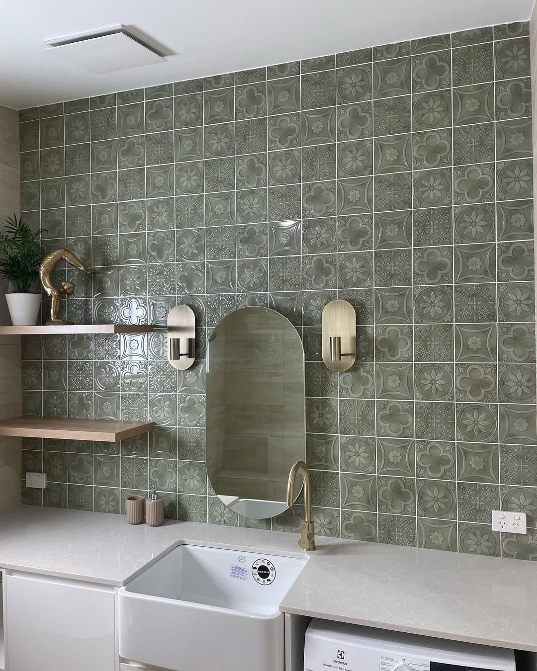 Green Tiled Bathroom With Oval Mirror, Brass Faucet and Sconces and Apron Sink — Seeto Tiling in Fingal Bay, NSW
