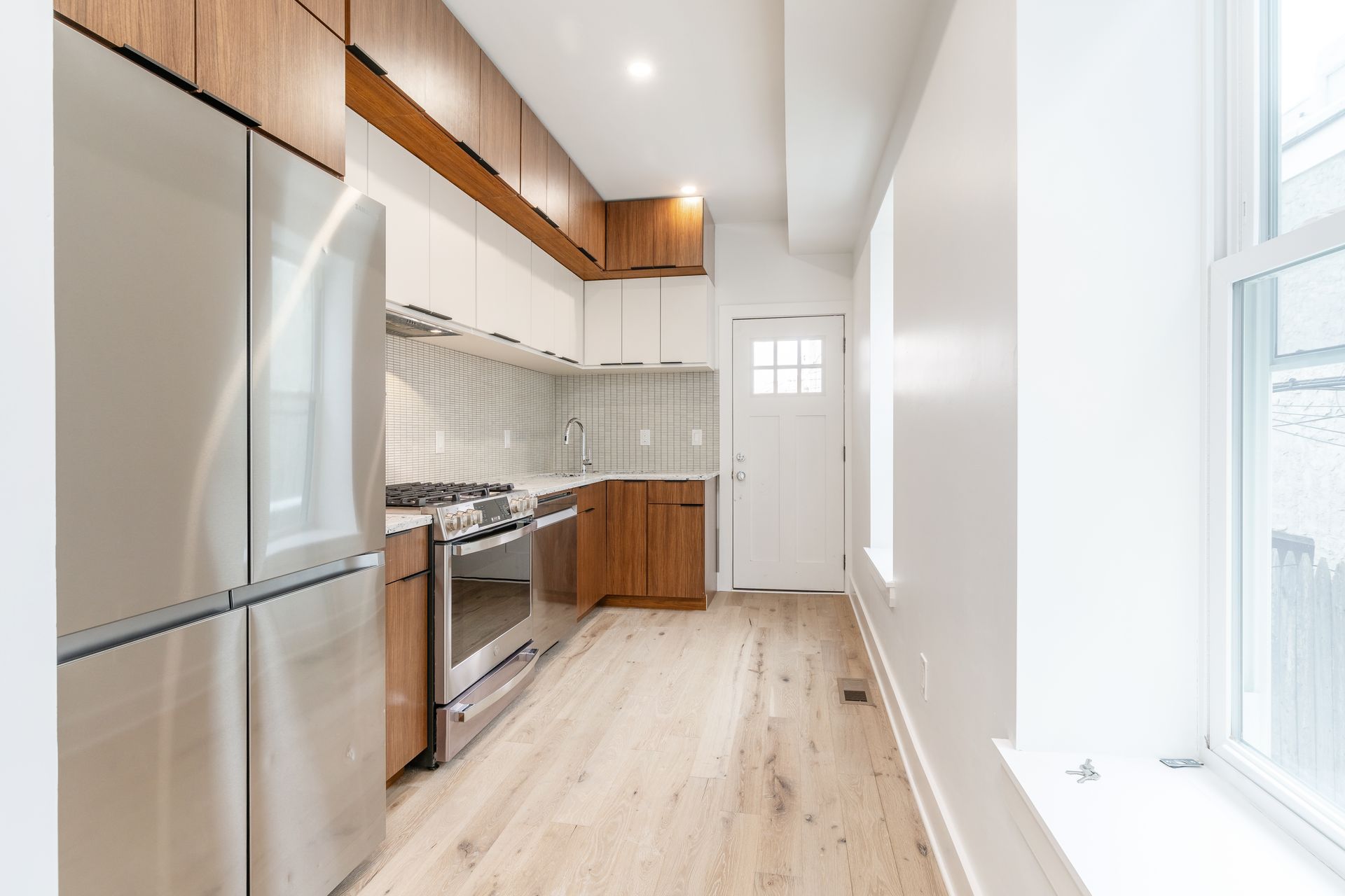 A kitchen with stainless steel appliances and wooden cabinets