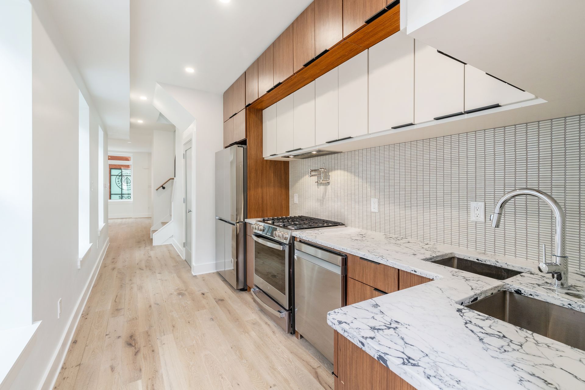 A kitchen with stainless steel appliances and marble counter tops