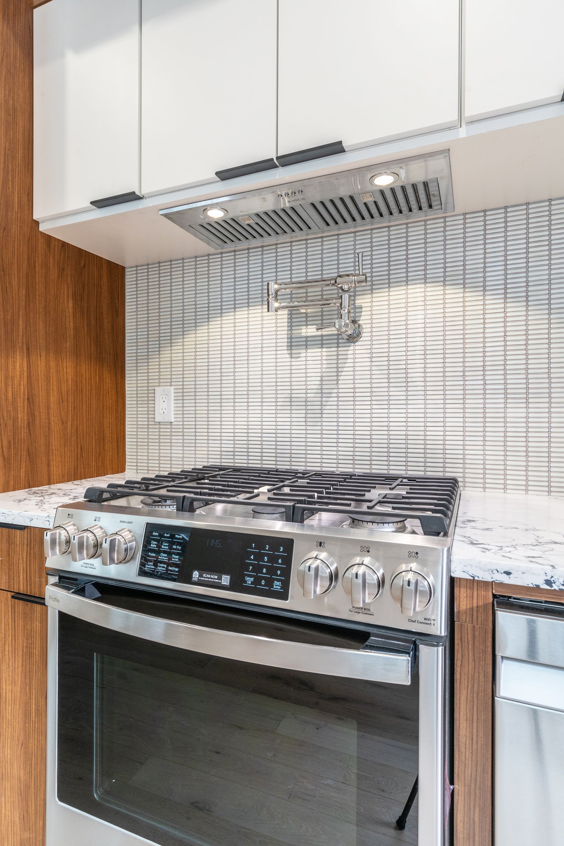 A kitchen with a stove top oven and a microwave.