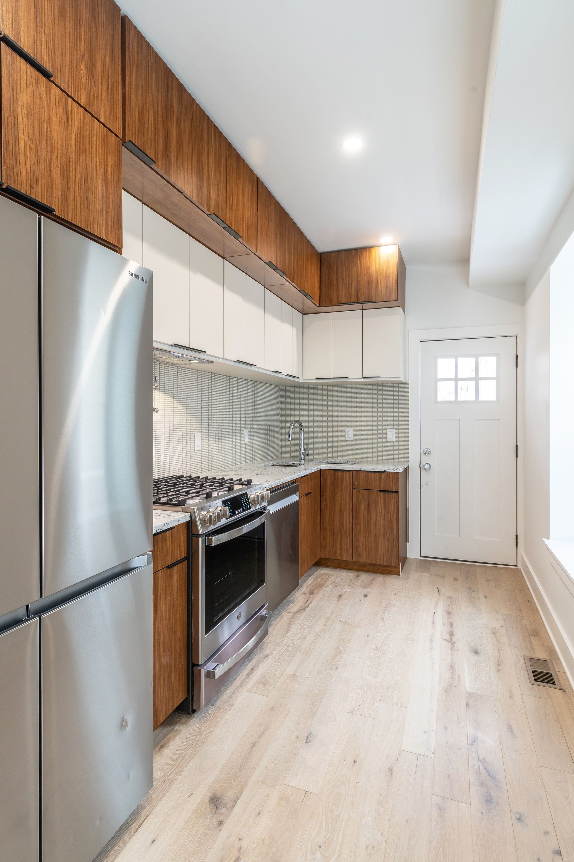 A kitchen with stainless steel appliances and wooden cabinets