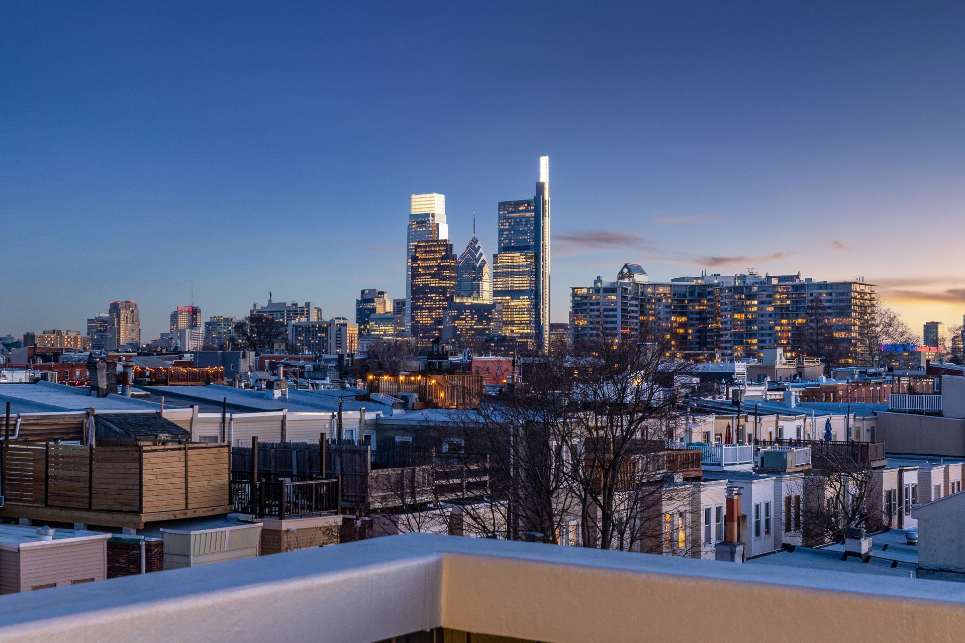 A view of a city skyline at night from a balcony.