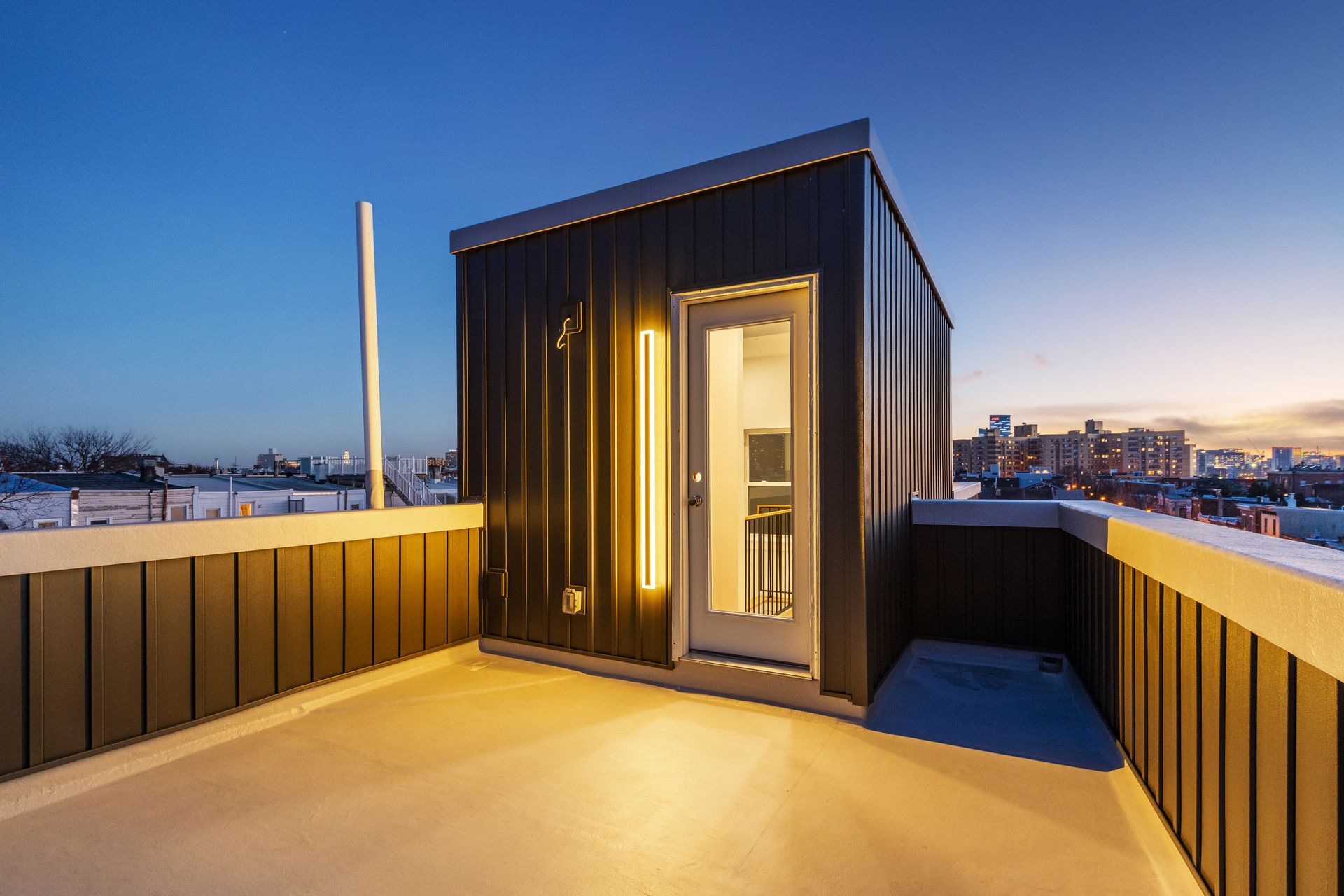 A rooftop deck with a small building on top of it.