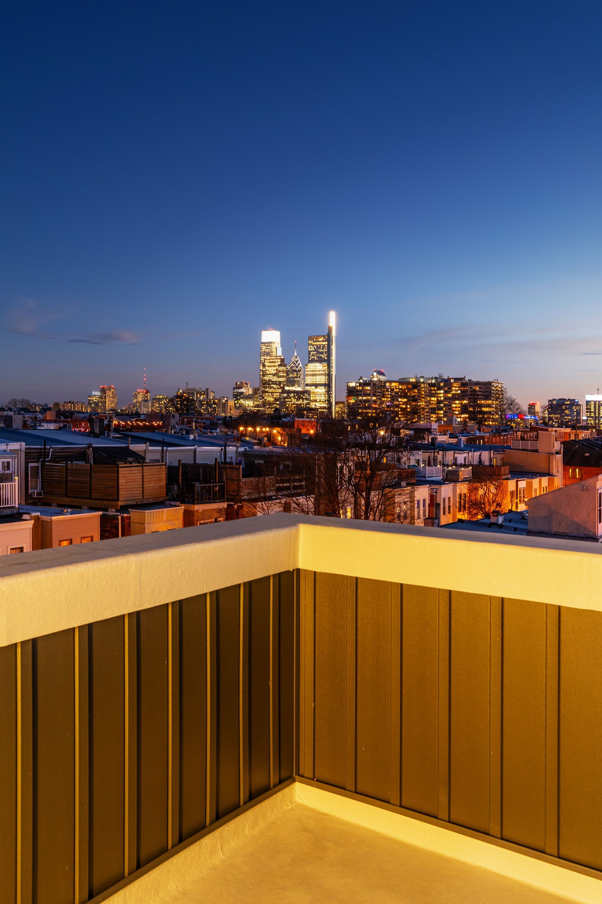 A balcony with a view of a city at night.