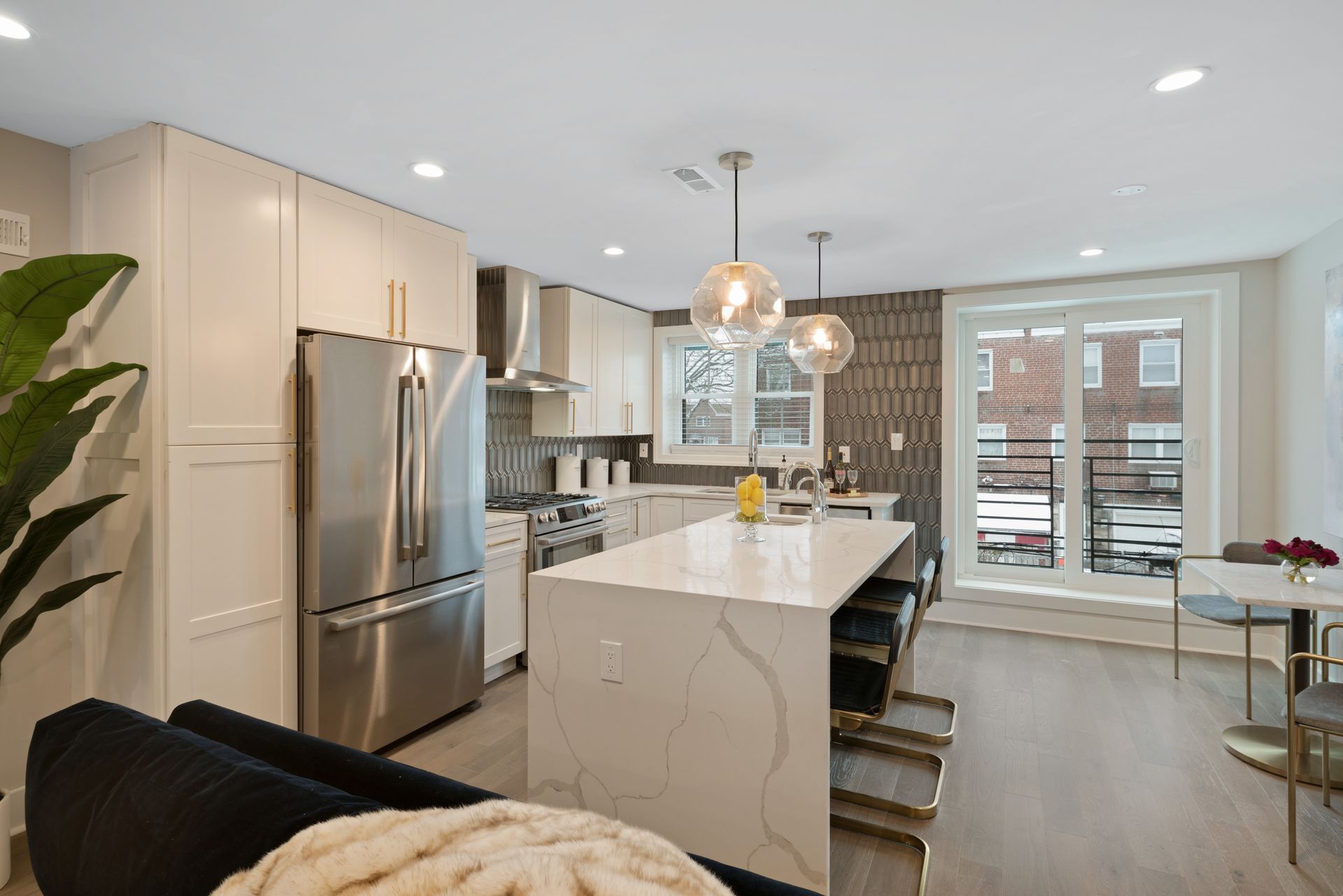 A kitchen with stainless steel appliances and a large island.