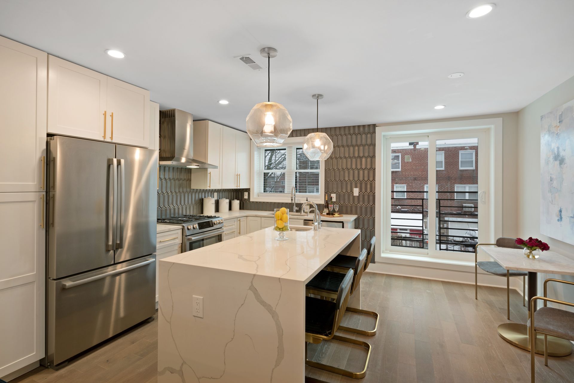 A kitchen with a large island and stainless steel appliances