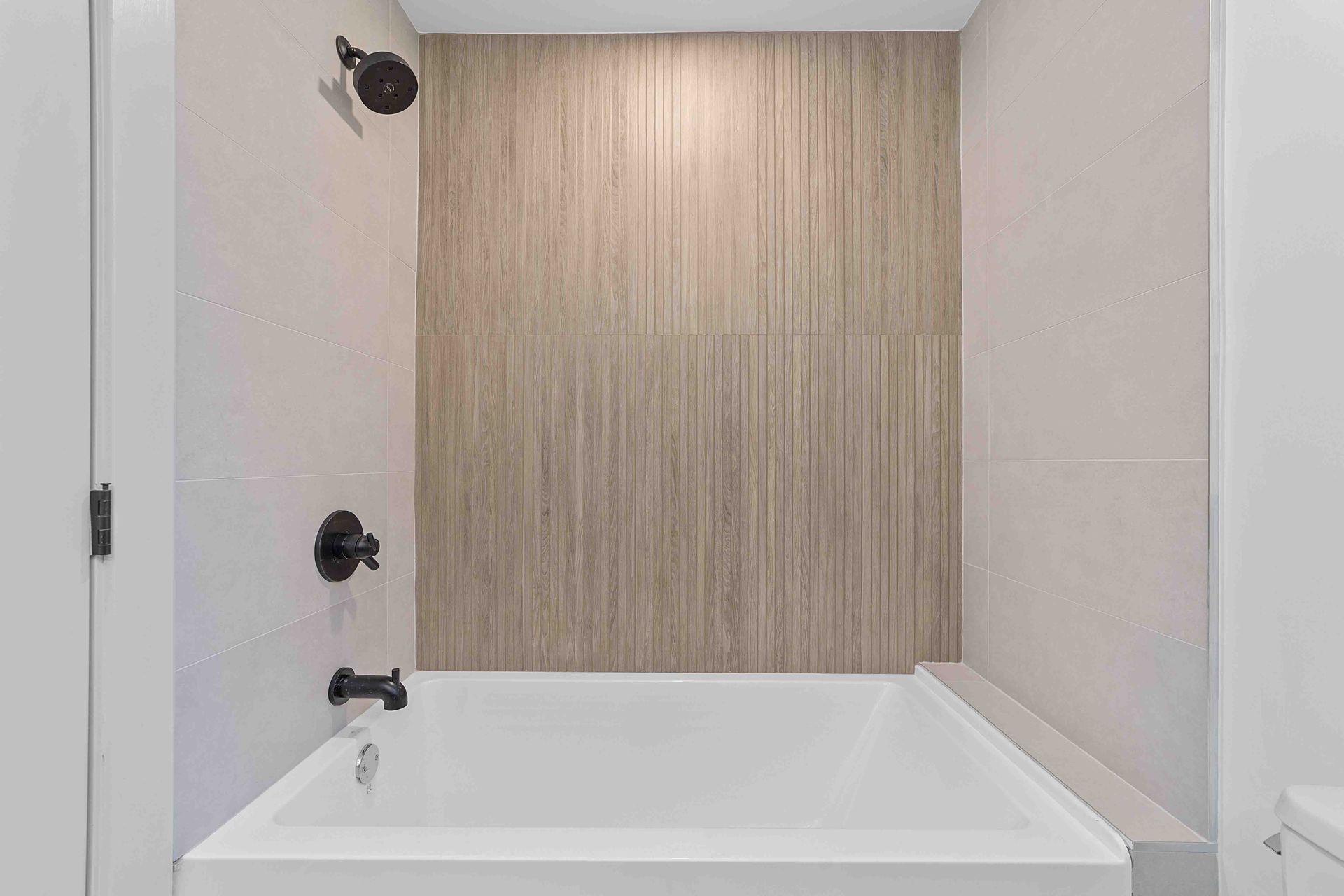 A bathroom with a bathtub and a shower.