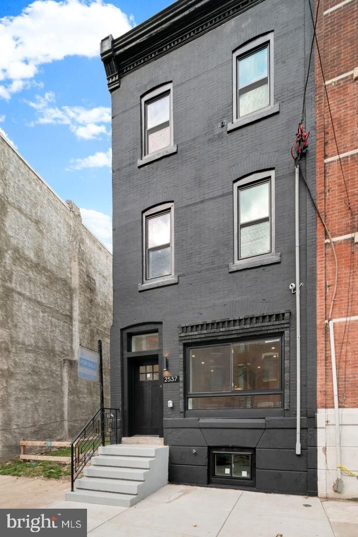 A black building with a lot of windows is for sale