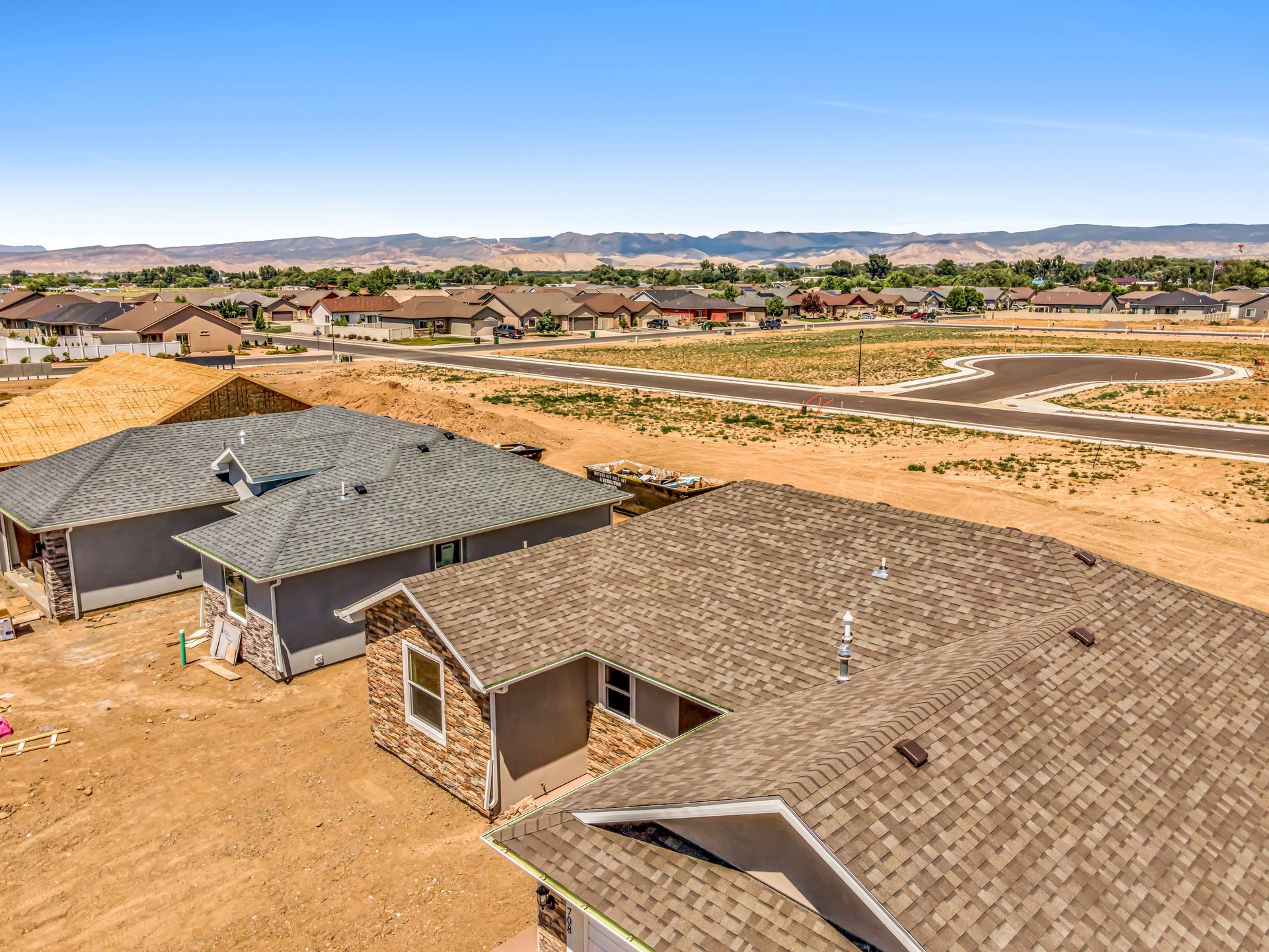 An aerial view of a house under construction in a residential area.