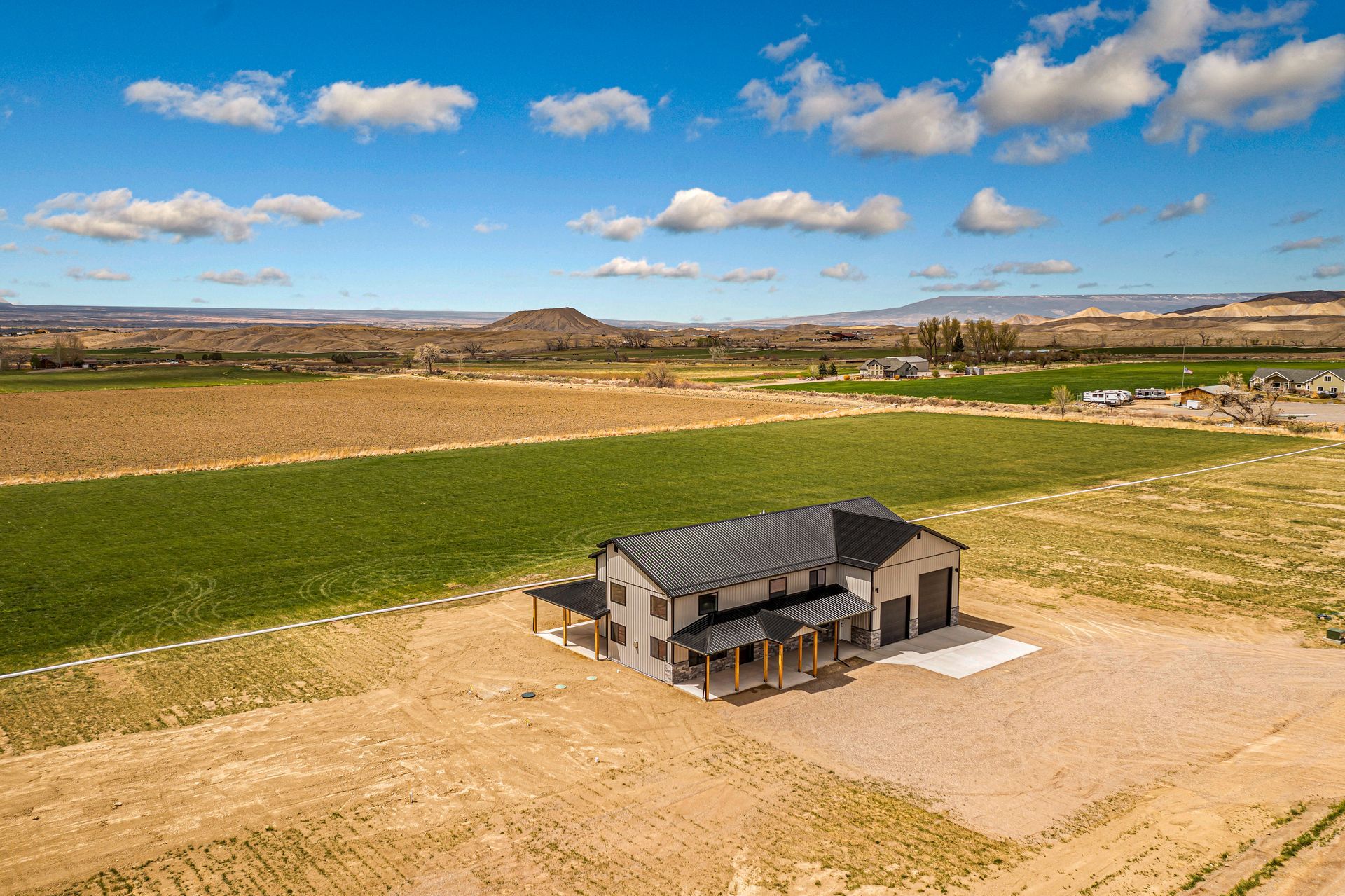 An aerial view of a house in the middle of a field.