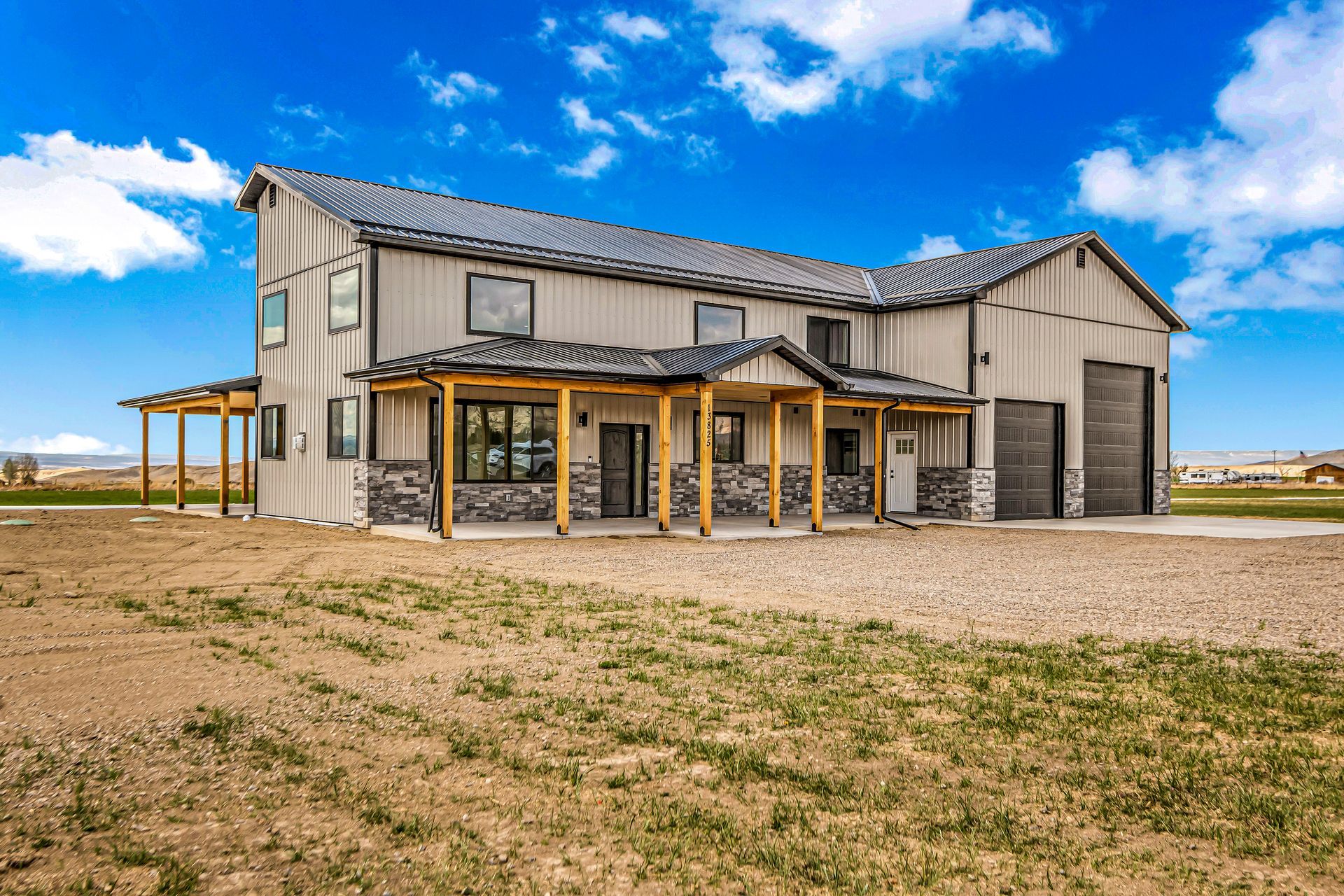 A large house is sitting in the middle of a grassy field.