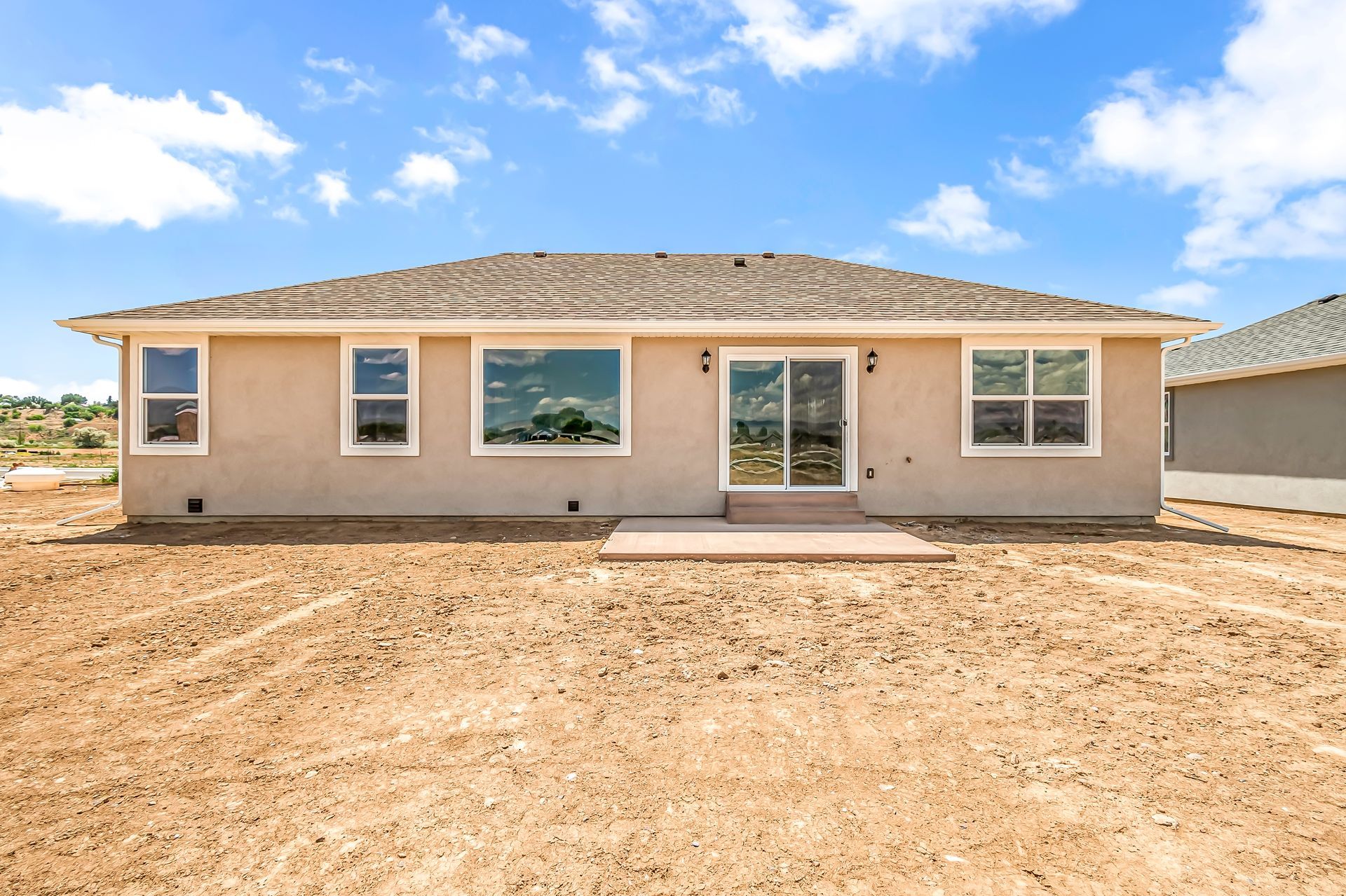 The back of a house with a lot of windows