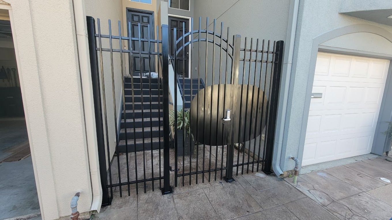 A wrought iron gate is sitting in front of a building.