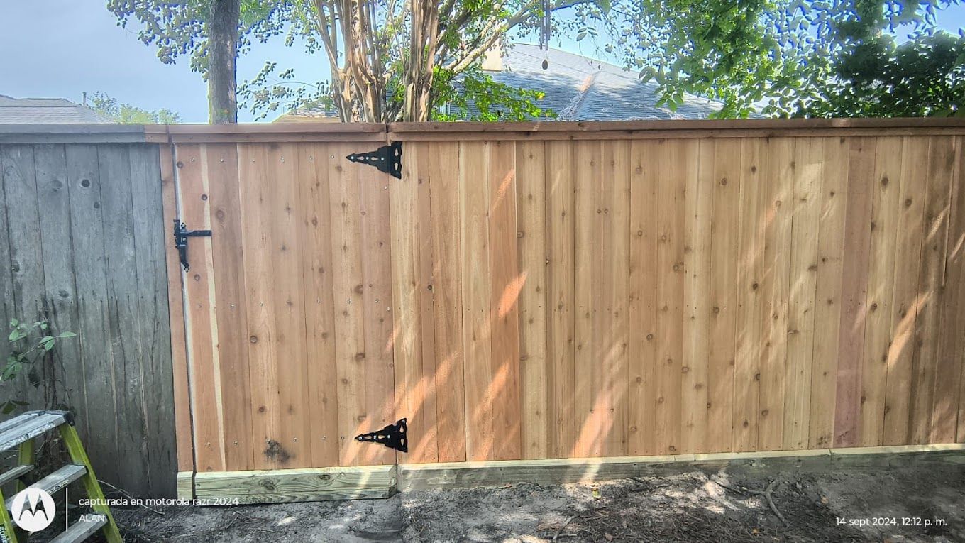 A wooden fence with a gate attached to it.