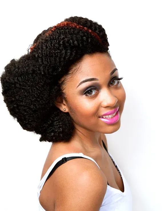 A woman wearing a braided hairstyle and pink lipstick