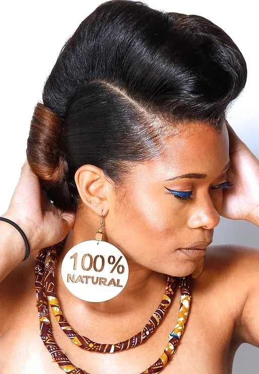 A woman wearing a necklace and earrings that say 100 % natural
