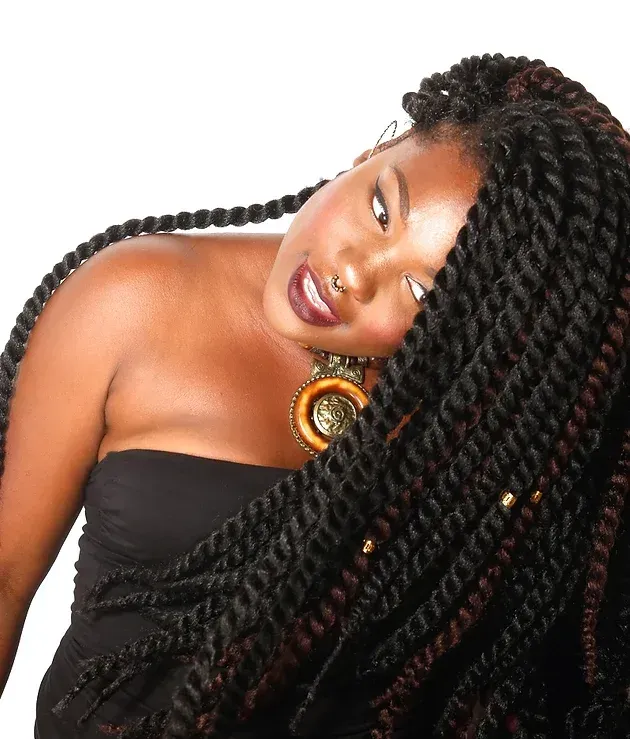 A woman with braids and a necklace on her neck